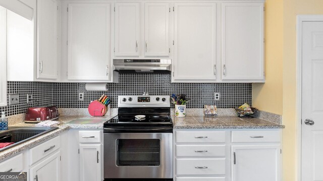 2675 Springside Ct, Douglasville, GA 30135 - kitchen with electric stove, under cabinet range hood, white cabinetry, and tasteful backsplash