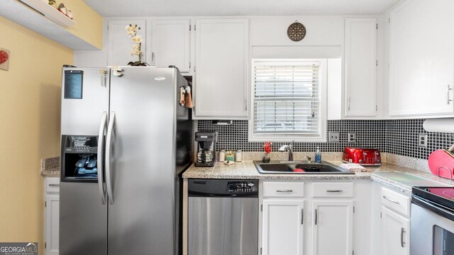 2675 Springside Ct, Douglasville, GA 30135 - kitchen featuring appliances with stainless steel finishes, a sink, white cabinetry, and light countertops