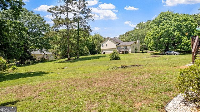 2675 Springside Ct, Douglasville, GA 30135 - view of green lawn featuring an attached garage and view of scattered trees