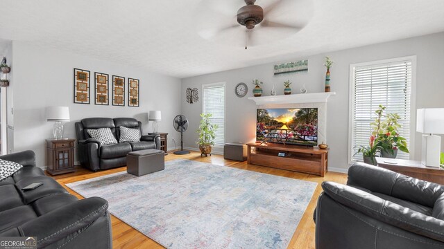 2675 Springside Ct, Douglasville, GA 30135 - living room featuring ceiling fan, light wood-type flooring, and baseboards