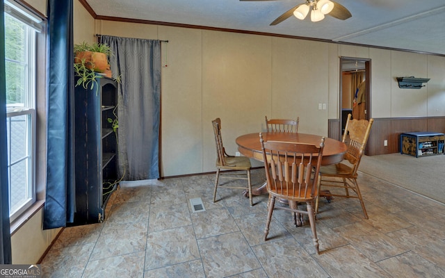 484 Tb Thornton Dr, Hartwell, GA 30643 - dining room with crown molding, ceiling fan, wooden walls, and stone finish floors