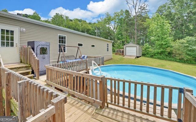484 Tb Thornton Dr, Hartwell, GA 30643 - outdoor pool with a yard, a wooden deck, an outdoor structure, and view of scattered trees