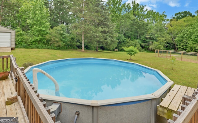 484 Tb Thornton Dr, Hartwell, GA 30643 - swimming pool featuring a yard, a wooden deck, and view of scattered trees