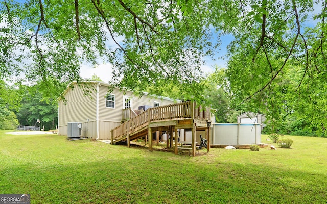 484 Tb Thornton Dr, Hartwell, GA 30643 - rear view of house featuring a yard, a wooden deck, an outdoor pool, stairs, and cooling unit