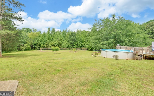 484 Tb Thornton Dr, Hartwell, GA 30643 - view of green lawn featuring an outdoor pool, a forest view, and a deck