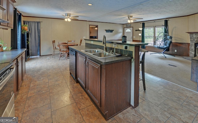 484 Tb Thornton Dr, Hartwell, GA 30643 - kitchen featuring a ceiling fan, a sink, dark countertops, a breakfast bar area, and a textured ceiling