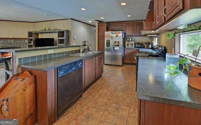 484 Tb Thornton Dr, Hartwell, GA 30643 - kitchen featuring stainless steel fridge, dishwasher, a sink, a kitchen island with sink, and dark countertops