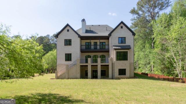 10765 Shallowford Rd, Roswell, GA 30075 - rear view of house featuring a balcony, a chimney, stairs, and a lawn
