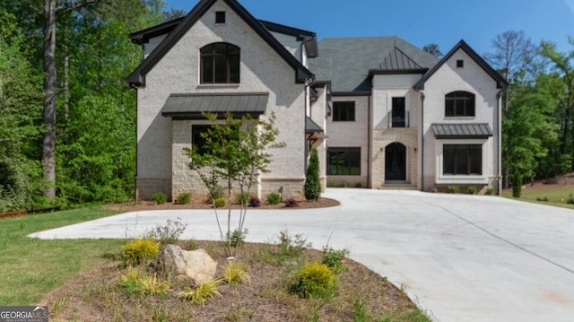10765 Shallowford Rd, Roswell, GA 30075 - french country style house featuring a standing seam roof, curved driveway, a metal roof, and a front lawn