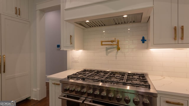 10765 Shallowford Rd, Roswell, GA 30075 - kitchen featuring high end range, custom range hood, white cabinetry, backsplash, and light stone countertops