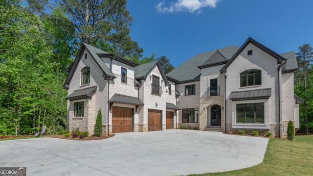 10765 Shallowford Rd, Roswell, GA 30075 - french country home with a standing seam roof, driveway, a garage, and a metal roof