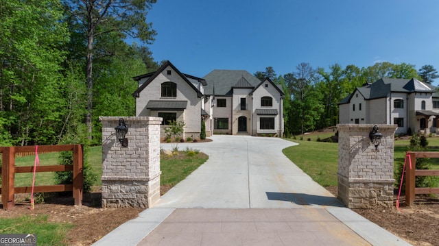 10765 Shallowford Rd, Roswell, GA 30075 - french country home with concrete driveway and stone siding