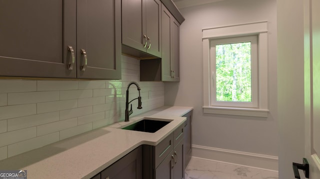 10765 Shallowford Rd, Roswell, GA 30075 - kitchen featuring marble look tiles, gray cabinetry, and decorative backsplash