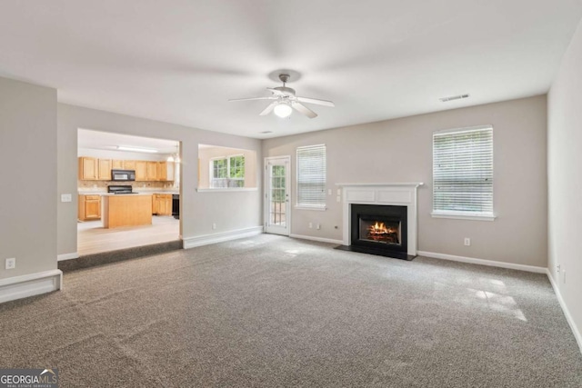2896 Chilhowee Dr, Atlanta, GA 30331 - unfurnished living room featuring light colored carpet, baseboards, a ceiling fan, and a fireplace with flush hearth