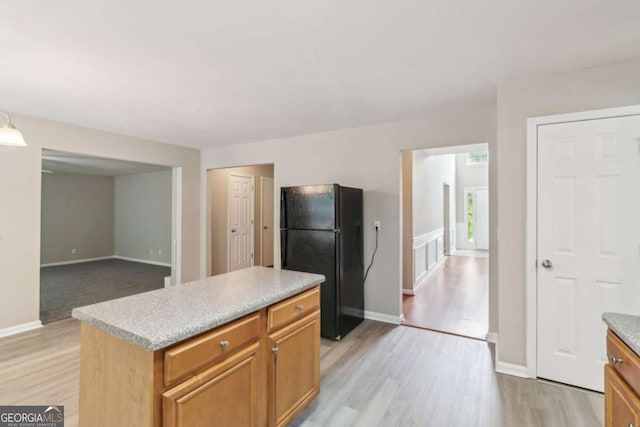 2896 Chilhowee Dr, Atlanta, GA 30331 - kitchen with freestanding refrigerator, light wood-style floors, light countertops, and baseboards