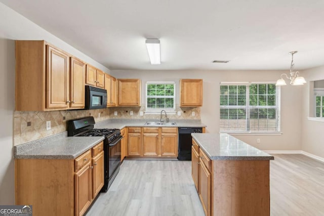 2896 Chilhowee Dr, Atlanta, GA 30331 - kitchen with black appliances, a sink, light wood-style floors, and decorative backsplash