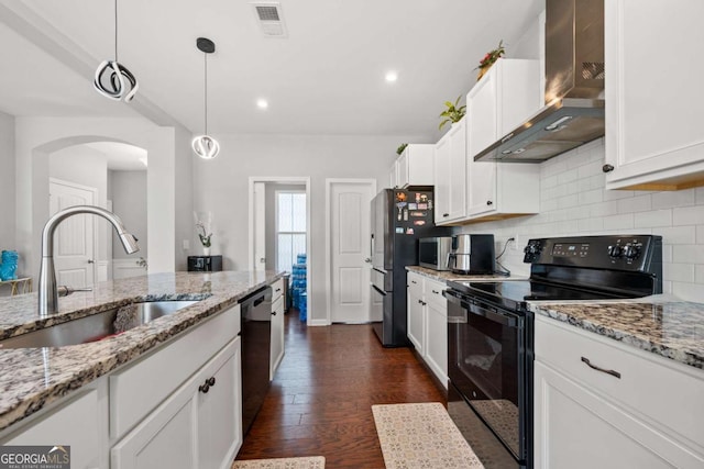 4607 Underwood Walk, Powder Springs, GA 30127 - kitchen featuring wall chimney exhaust hood, black appliances, a sink, arched walkways, and decorative backsplash