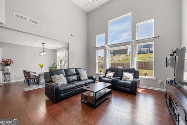 4607 Underwood Walk, Powder Springs, GA 30127 - living room with a towering ceiling, wood-type flooring, and baseboards
