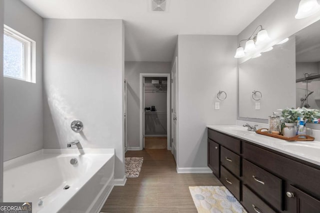 4607 Underwood Walk, Powder Springs, GA 30127 - full bath featuring a bath, double vanity, a spacious closet, wood finished floors, and baseboards