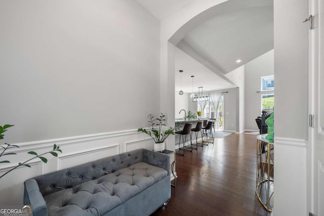 4607 Underwood Walk, Powder Springs, GA 30127 - corridor featuring dark wood-style floors, arched walkways, a chandelier, wainscoting, and a high ceiling