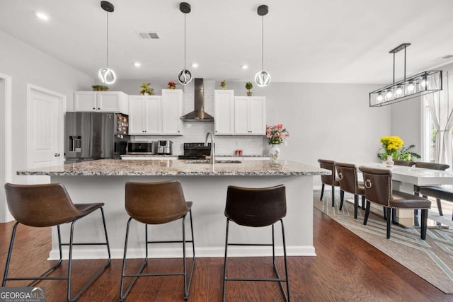 4607 Underwood Walk, Powder Springs, GA 30127 - kitchen with wall chimney exhaust hood, stainless steel appliances, backsplash, a sink, and white cabinets