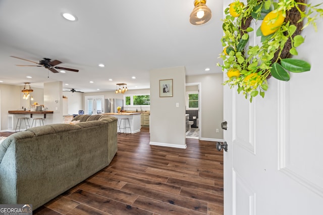 living room featuring ceiling fan, dark wood-type flooring, recessed lighting, and baseboards