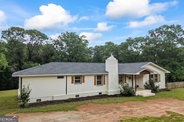 view of front of house with crawl space, roof with shingles, a porch, brick siding, and fence