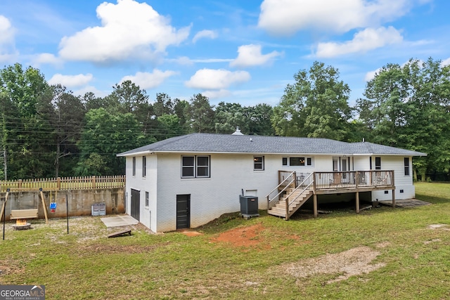 rear view of property featuring a deck, an attached garage, and cooling unit