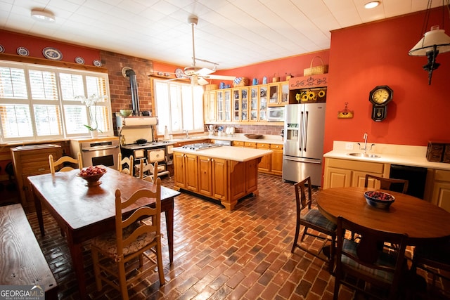3530 Refuge Rd, Jasper, GA 30143 - kitchen featuring appliances with stainless steel finishes, a sink, brick flooring, light countertops, and glass insert cabinets