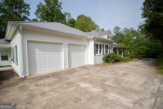 3530 Refuge Rd, Jasper, GA 30143 - view of home's exterior featuring a garage, driveway, metal roof, and a chimney