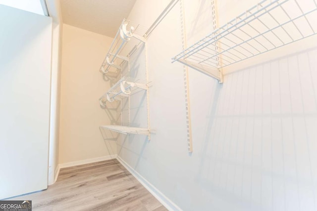 spacious closet with wood finished floors