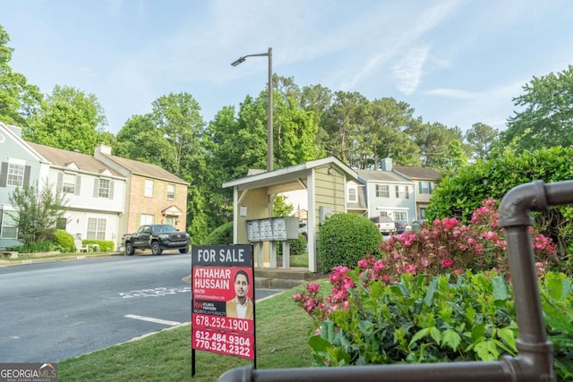 exterior view of mail area, parking, and a residential view