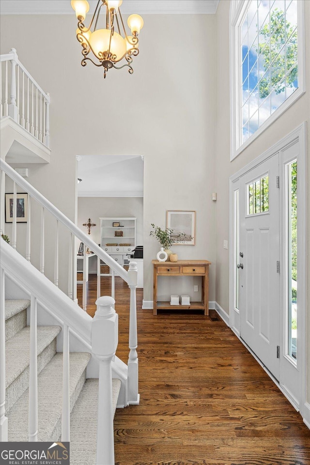 235 Foxley Way, Roswell, GA 30075 - foyer entrance with a high ceiling, a chandelier, wood finished floors, stairway, and crown molding