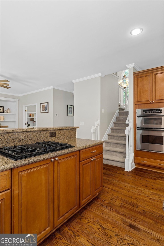235 Foxley Way, Roswell, GA 30075 - kitchen featuring black gas stovetop, crown molding, dark wood-type flooring, stainless steel double oven, and light stone counters