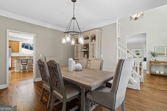 235 Foxley Way, Roswell, GA 30075 - dining space with a chandelier, stairs, dark wood finished floors, and crown molding
