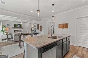 2700 Westgate Park Dr Unit 1A, Loganville, GA 30052 - kitchen with dishwasher, a sink, ornamental molding, wood finished floors, and decorative light fixtures