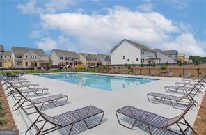 2700 Westgate Park Dr Unit 1A, Loganville, GA 30052 - community pool featuring a patio area, a residential view, and fence