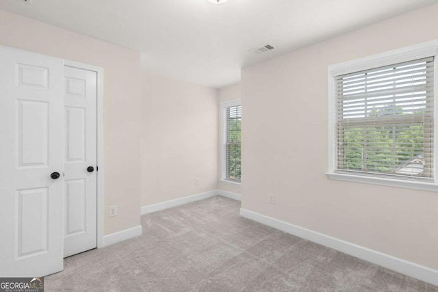 unfurnished bedroom with carpet and baseboards