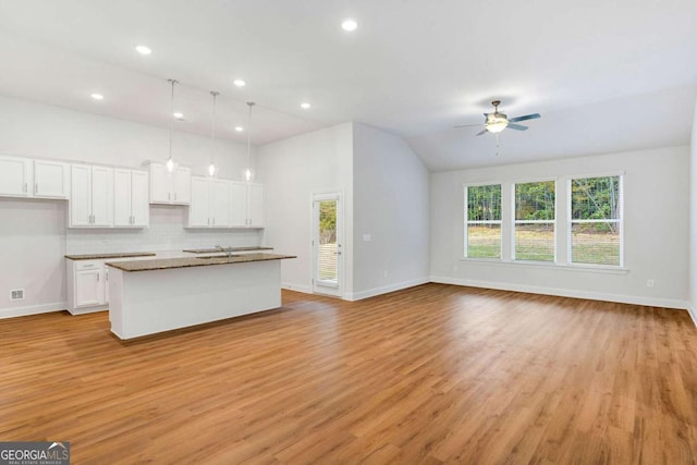 34 Cooper Dr Unit 53, Mansfield, GA 30055 - kitchen featuring ceiling fan, a kitchen island with sink, light wood-style floors, white cabinetry, and recessed lighting