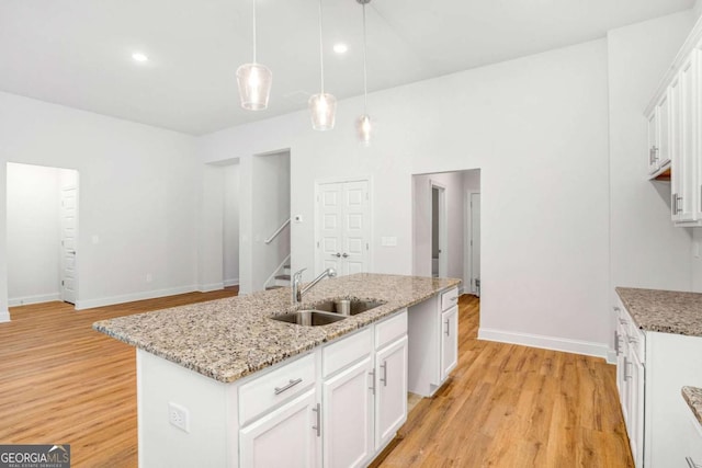 34 Cooper Dr Unit 53, Mansfield, GA 30055 - kitchen with light wood-style flooring, a kitchen island with sink, pendant lighting, white cabinetry, and recessed lighting