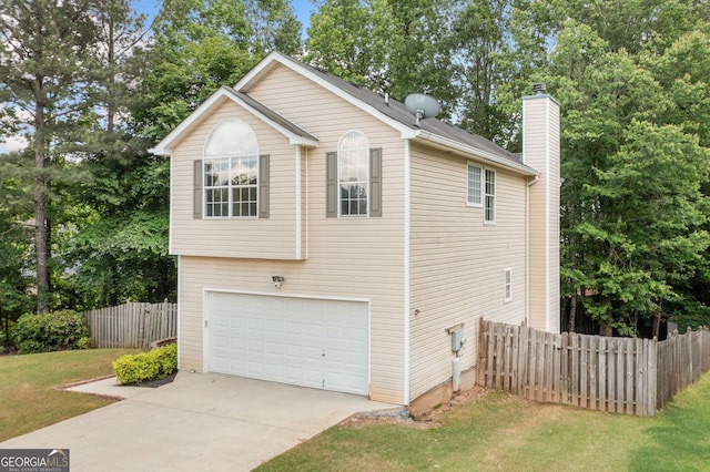 view of side of property featuring a chimney, concrete driveway, and a garage