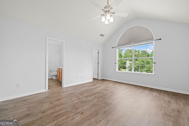 unfurnished living room featuring a ceiling fan, wood finished floors, vaulted ceiling, and baseboards