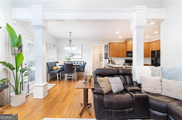 59 Creekside Blf, Hiram, GA 30141 - living room featuring decorative columns, light wood-style floors, recessed lighting, and baseboards
