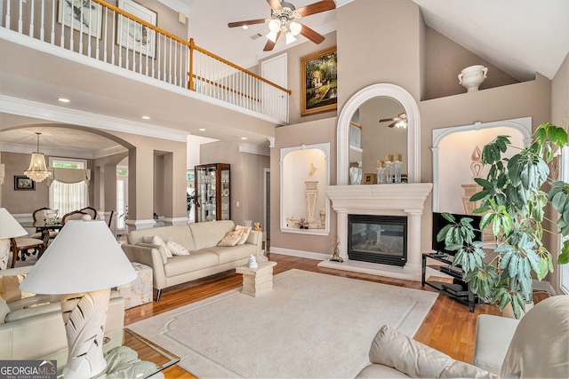 127 Courts Of Hampton, Hampton, GA 30228 - living area featuring ceiling fan, a high ceiling, wood finished floors, arched walkways, and crown molding