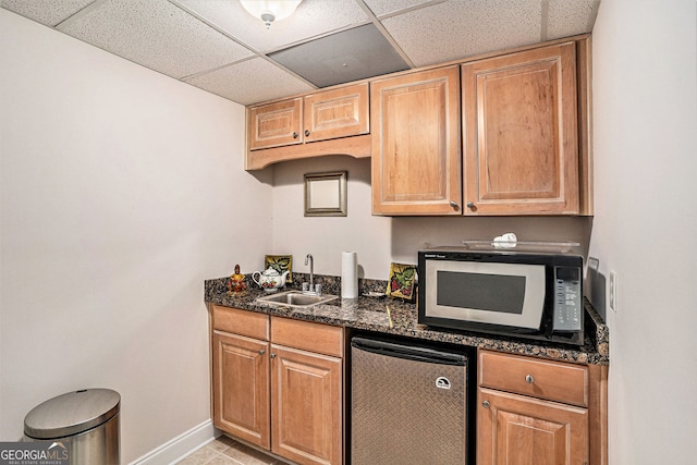 127 Courts Of Hampton, Hampton, GA 30228 - kitchen with white microwave, fridge, a drop ceiling, and dark stone countertops