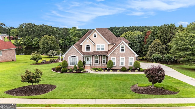 127 Courts Of Hampton, Hampton, GA 30228 - traditional-style house with brick siding, a front yard, and covered porch
