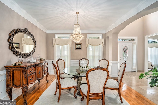 127 Courts Of Hampton, Hampton, GA 30228 - dining area with healthy amount of natural light, a chandelier, wainscoting, ornamental molding, and arched walkways