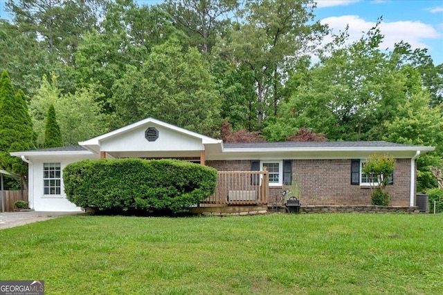 ranch-style house with a front yard, brick siding, and central air condition unit