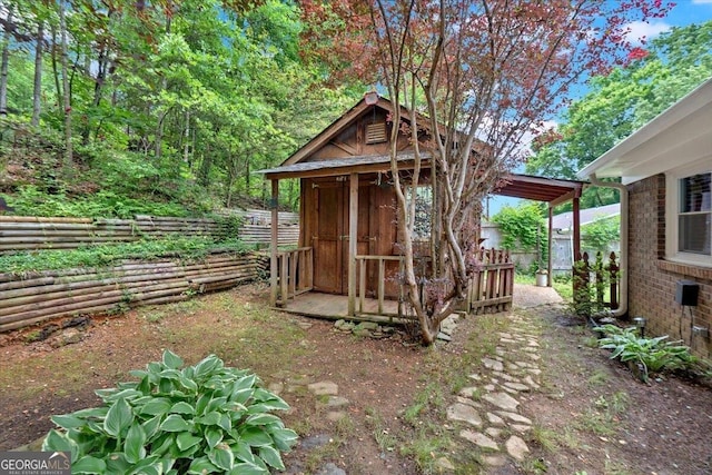 view of outdoor structure featuring an outbuilding and a fenced backyard