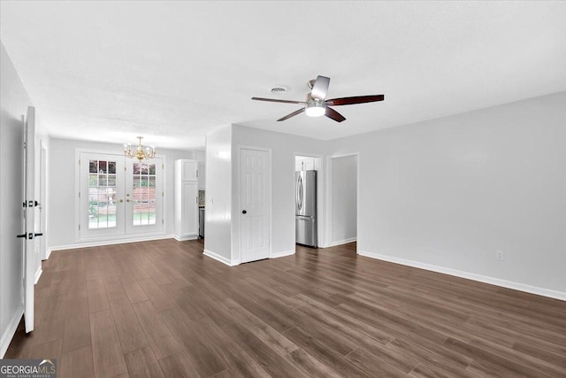 unfurnished living room with a chandelier, baseboards, dark wood-style floors, and ceiling fan